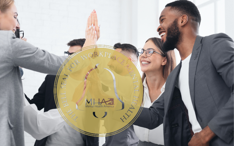 a group of happy employees with the Bell Seal For Workplace Mental Health