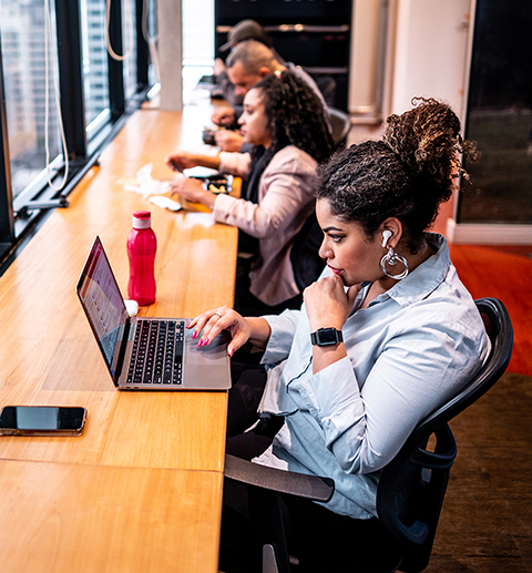 Group of employees working using laptop at office