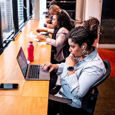 Group of employees working using laptop at office